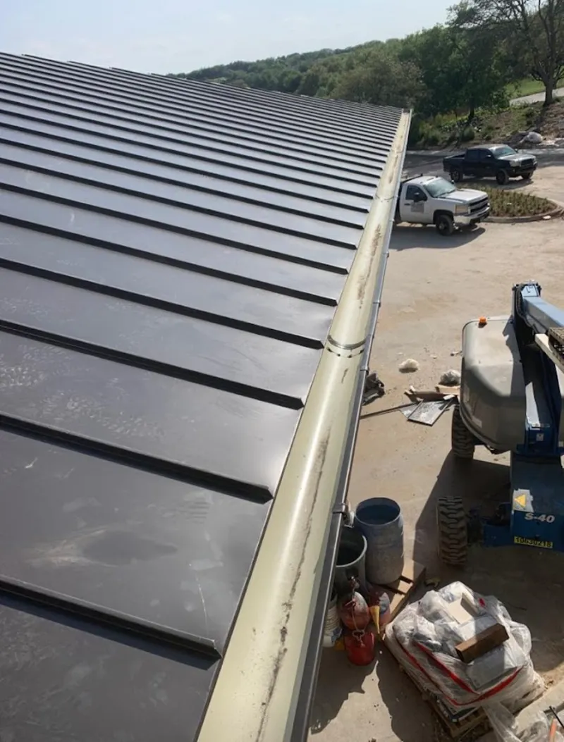 Standing seam panel and gutter detail on a metal roofing jobsite in Antioch